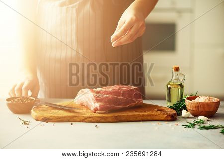 Wooman Hands Cutting Beef Meat On Wooden Chopping Board, Rosemary, Oil, Salt, Pepper. Girk Cooking P