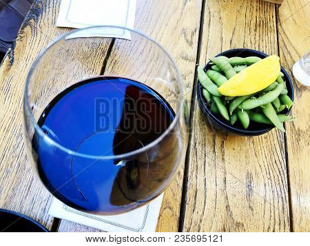 Wine In Glass Selective Focus Motion Blur Red Wine In A Glass. Wine With Peas And Lemon