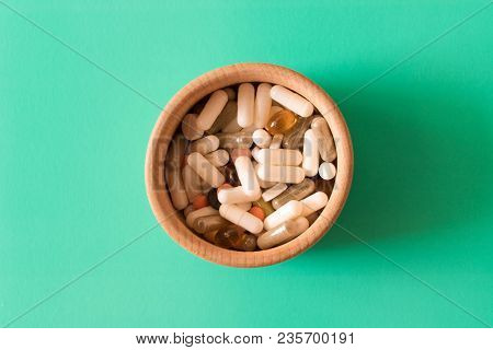 Lots Of Colorful Pills In A Plate On Turquoise Background . The Concept Of A Healthy Lifestyle .