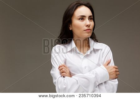 Beautiful Girl In A White Shirt Shows Emotions. On A Light Background.