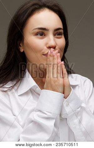 Beautiful Girl In A White Shirt Shows Emotions. On A Light Background.