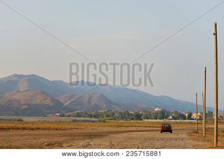 Serene Landscape With Road And Car In Natural Park, Almeria, Andalusia, Spain