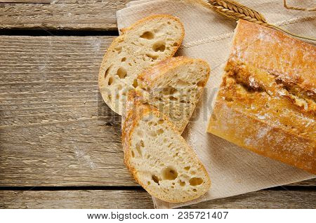Ciabatta Bread. Slices Of Ciabatta On A Wooden Table On Linen Cloth. Rustic, Rustic Style. Top View,