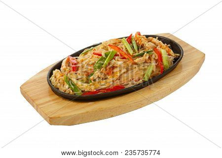 Funchoza, Chicken, Pork With Meat, Red Pepper And Green Onions, Serving In Hot Frying Pan, On Wooden