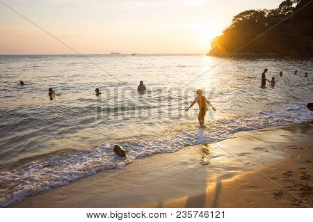 Family Of Three Having Fun On Tropical Beach