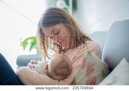 Young Mother, Holding Tenderly Her Newborn Baby Boy