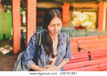 Travel Concept. Beautiful Girl Is Having Severe Stomach Pain While Traveling. Asian Women Are Not Co