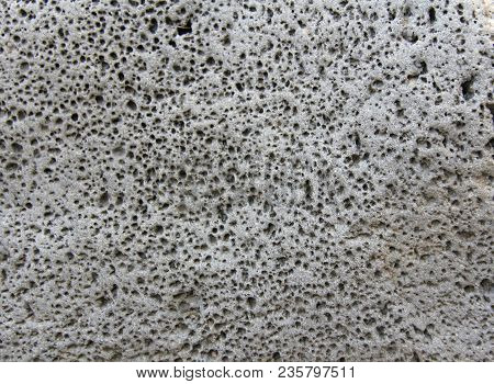 Background Of The Gray Stones Of Volcanic Lava. Gray Background. Old Gray Stones. Gorge Of Alcantara