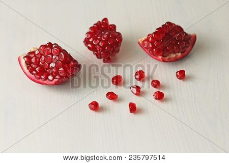 Big Ripe Red Granets Or Garnets. Fruits Of Red Ripe Pomegranate On The White Background. Vegetarian 