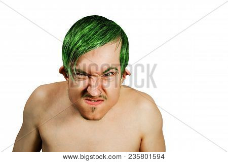 Young Angry Guy In The Image Of A Goblin With Green Hair, Grimaces. Isolated On White Background.