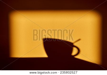 Morning Golden Sunny Shadow On The Wall - A Cup With A Teaspoon In It.