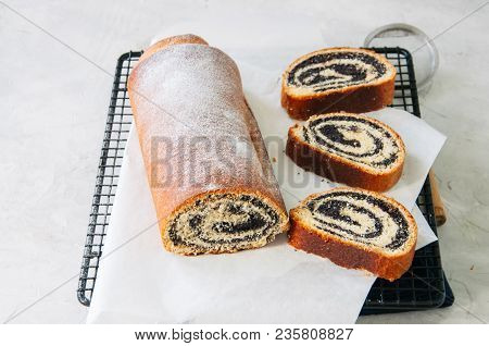 Traditional Polish Festive Pastry - Makowiec- Poppy Seed Roll Served On A Wire Rack. White Stone Bac