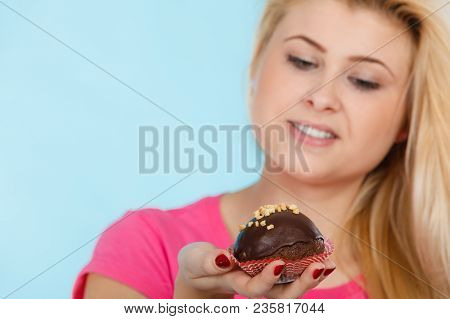 Diet, Sweets, Food Concept. Woman Holding Delicious Chocolate Cupcake With Peanut Frosting About To 