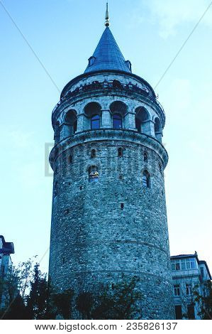 Galata Tower In The Old City Of Istanbul Standing Tall In Fading Daylight With A Lit Window
