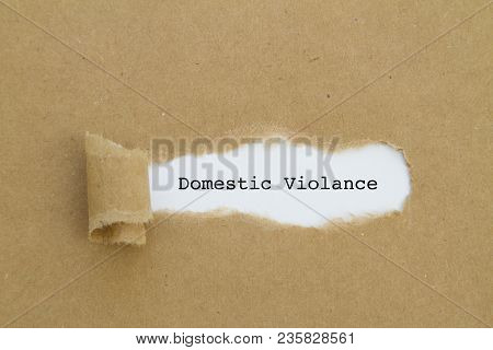 Domestic Violance Word Written Under Torn Paper Concept.