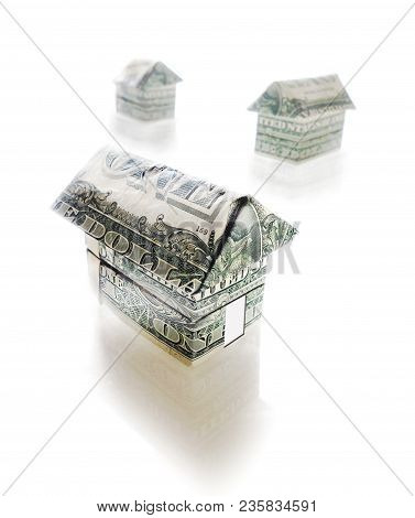 Paper Origami Homes Made Out Of Dollar Bills On White