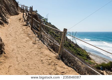 A Trail Winding Down A Cliff Toward The Beach At Beacon Beach In Encinitas, California.