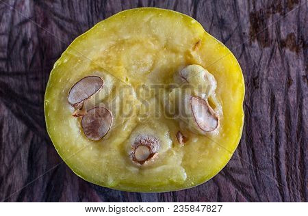 Cut Half Rare Araza Fruit On Rustic Background