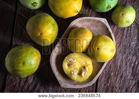 Rare Araza Fruits In A Wooden Bowl On Rustic Background