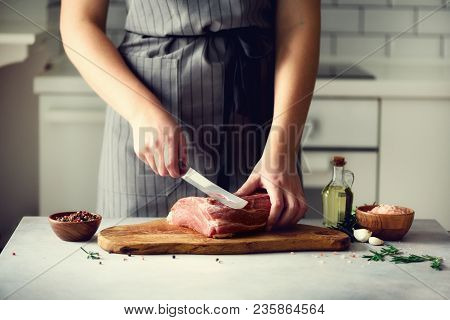 Wooman Hands Cutting Beef Meat On Wooden Chopping Board, Rosemary, Oil, Salt, Pepper. Girk Cooking P