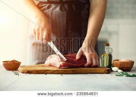Wooman Hands Cutting Beef Meat On Wooden Chopping Board, Rosemary, Oil, Salt, Pepper. Girk Cooking P