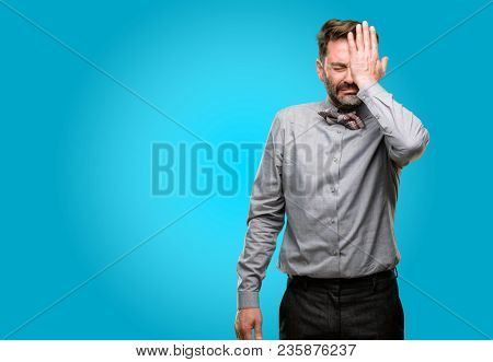 Middle age man, with beard and bow tie stressful keeping hand on head, tired and frustrated