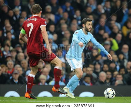 MANCHESTER, ENGLAND - APRIL 10: James Milner  and Bernardo Silva  during the Champions League quarter final match between Manchester City and Liverpool at the Etihad Stadium on April 10, 2018 