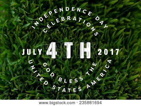 White fourth of July graphic against grass