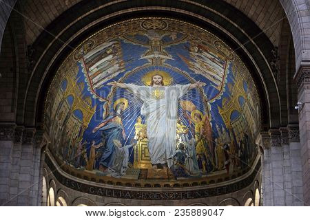 PARIS, FRANCE - JANUARY 08, 2018: Christ in Majesty is surrounded by the Virgin Mary, Joan of Arc and St. Michael, mosaic by Luc-Olivier Merson, Basilica of the Sacred Heart of Jesus in Paris.