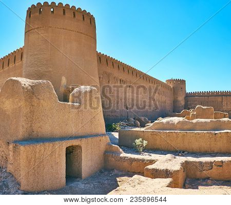The Huge Watchtower Of Rayen Castle With Ruins Of Adobe Residential Houses On The Foreground, Iran.