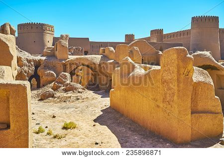 Adobe Towers Of Rayen Castle, Rising Behind The Ruins Of Residential Buildings, Iran.