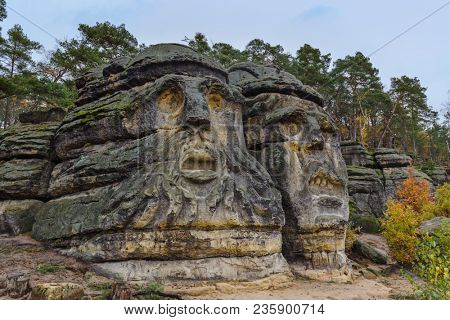 Sculptures Devil's heads in the village Zelizy - Czech republic - travel and architecture background