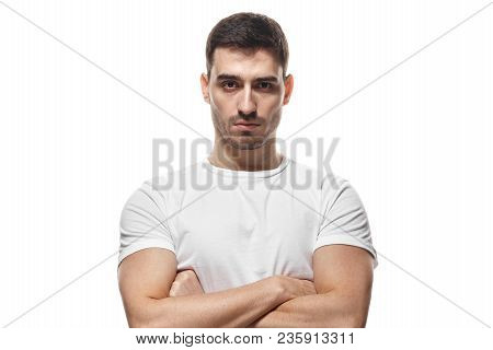 Tough Guy Standing With Crossed Arms Isolated On White Background. Serious Young Man Portrait Concep