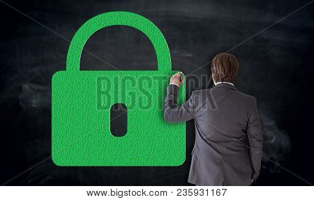 Businessman Paints Green U-lock On Blackboard Concept.