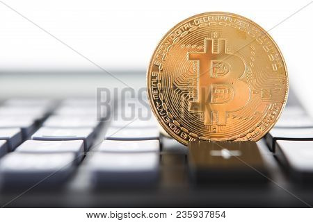 Bitcoin On The Keyboard Of The Calculator. Shallow Depth Of Field. A Visual Representation Of Digita