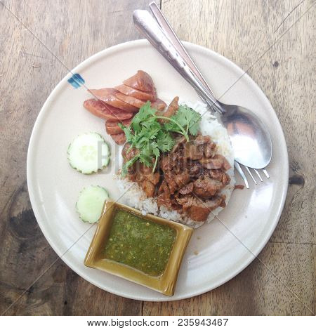 Baked Pork On Rice Served With Seafood Sauce