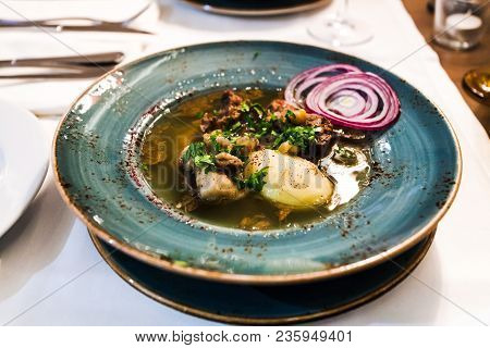 Traditional Caucasian Soup Putuk (piti) From Mutton Brisket, Chick Peas, Potatoes In Plate On Table