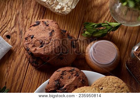 Side View Of A Plate Of Chocolate Chip Cookies On A White Plate Homespun Tablecloth Illuminated With