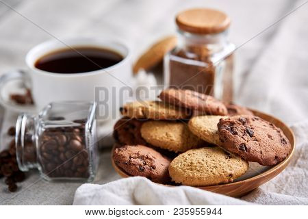 Side View Of A Plate Of Chocolate Chip Cookies On A White Plate Homespun Tablecloth Illuminated With