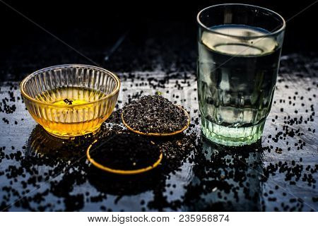 Close Up Of Kalonji Or Roman Coriander With Water And Honey On Wooden Surface Beneficial For Diabete