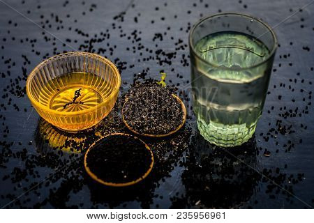 Close Up Of Kalonji Or Roman Coriander With Water And Honey On Wooden Surface Beneficial For Diabete