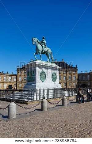 Copenhagen, Denmark- May 03, 2013: Amalienborg, Riding Statue Of King Frederick V. In The Background