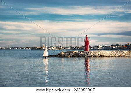 Small Sailing Boat Falls In The Port Of Trani In Puglia At Sunset