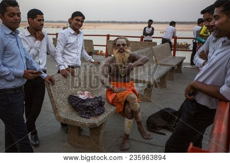VARANASI, INDIA - MAR 26, 2018: Sadhu or Baba (holy man) on the ghats of Ganges river. Normally a sadhu is a monk, renounced, renounced material enjoyment. In India from 4 to 5 million sadhu.