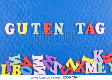Guten Tag Word On Blue Background Composed From Colorful Abc Alphabet Block Wooden Letters, Copy Spa
