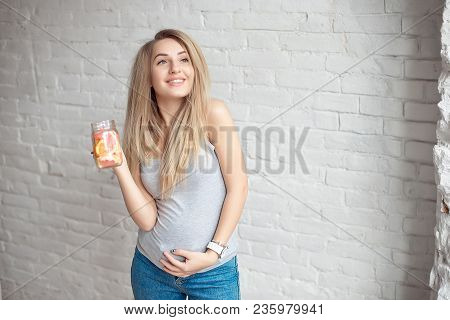 Caucasian Young Girl 20-25 Years Old Holding Bottled Glass Of Fresh Summer Lemonade With Straw.