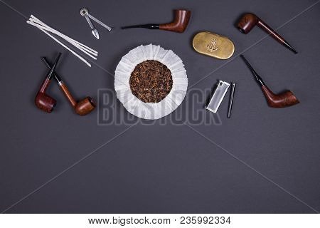 Different Smoking Tobacco Pipes, Tobacco In The Can And Tobacco Accessories On Dark Background With 