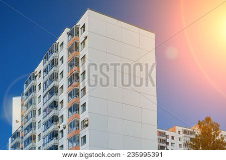 Modern Concrete Blocks Apartment Building With A Deep Blue Sky Background. Toned.