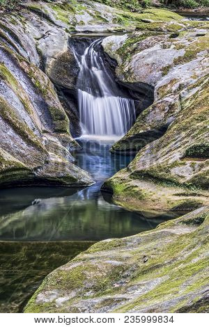 Water Splashes Down A Chute Carved By Water Into Moss-covered Rock At Upper Robinson Falls At Boch H