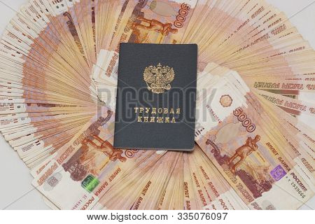 Labor Book On Russian Banknotes. The Labor Book Of A Citizen Of The Russian Federation Lies On A Lar